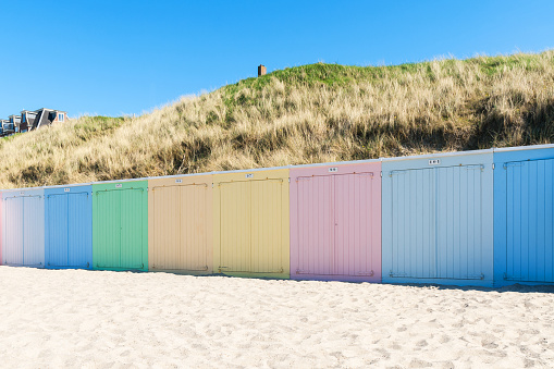 Beach cabins in a row, in the North sea, in The Netherlands. Domburg beach