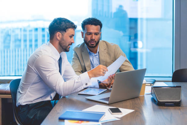 istock Business people working on a document with a laptop and digital tablet 1407200726