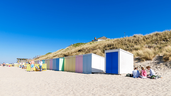 Beach cabins in a row, in the North sea, in The Netherlands. Domburg beach. April 17, 2022.