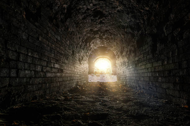 istock Old ruined brick vaulted tunnel. Dark passage. Underground communication 1407203518