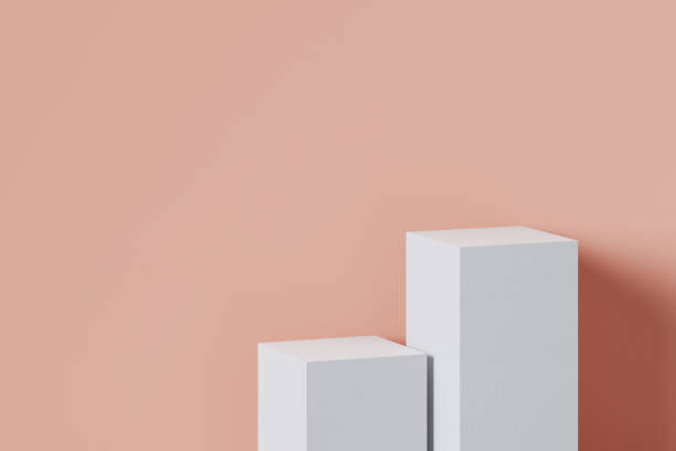 istock Stage podium stand background. Two white boxes are placed beside the peach colored walls. 1407204873