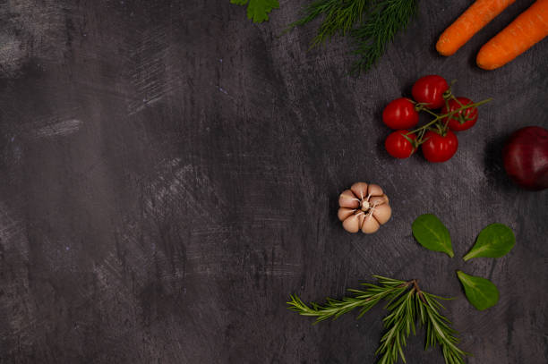 istock Herbs and fresh vegetables for cooking on dark metal background with space for text. Top view. 1407207192