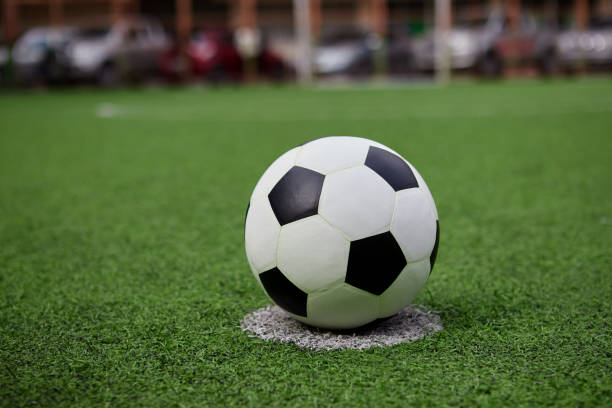 istock Football on the grass field 1407214598