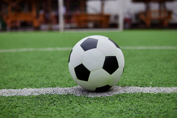 istock Football on the grass field 1407214601