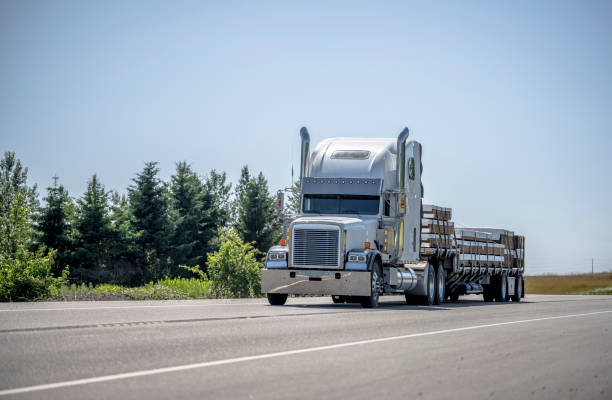 a semi truck is seen driving on a road