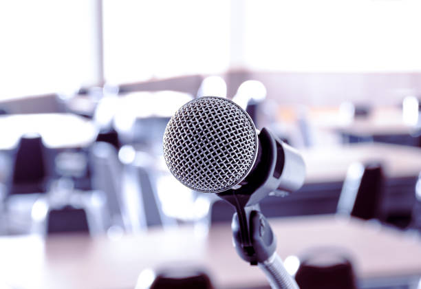 istock Close up microphone with tripod on stage in seminar room. 1407220164