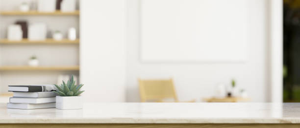 istock Modern white marble tabletop with empty space over blurred minimal white home living room 1407221221