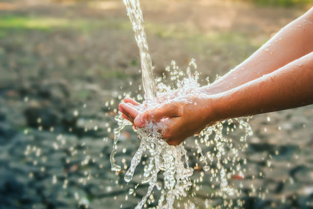 istock Water pouring on hand in morning ligth background 1407221968