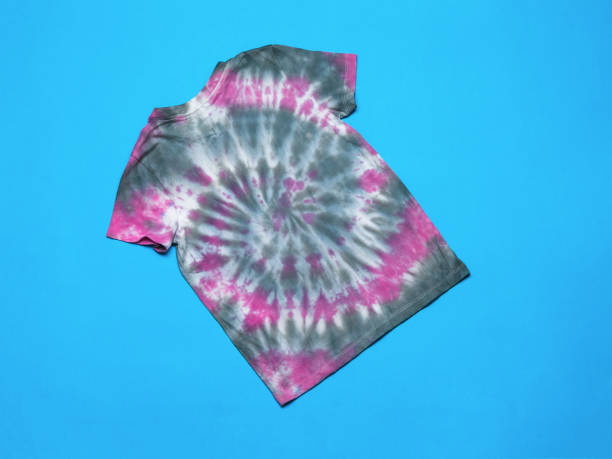 istock Red and gray tie dye T-shirt on a blue background. Flat lay. 1407224826