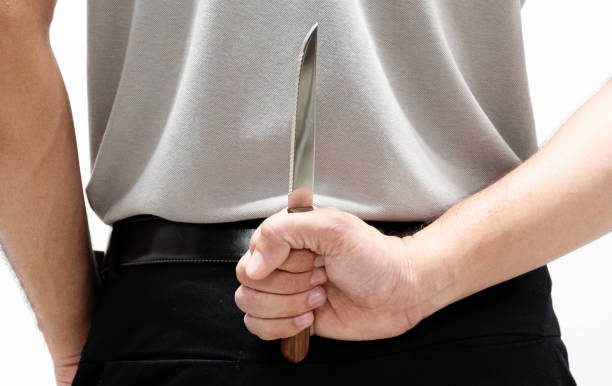 istock Blackmail concept man with a knife behind his back 1407227305