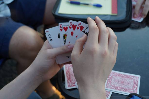 Cards in Teen Boy's Hand Teen boy's hand playing cards. hand of cards stock pictures, royalty-free photos & images