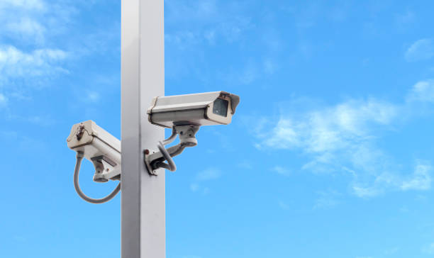 istock Outdoor white CCTV on pole with blue sky background and copy space 1407229052
