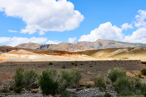 A valley in the Altai Mountains on a sunny day with looming clouds. A picturesque place.