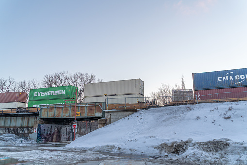 March 17 2022 - Winnipeg Manitoba Canada - Train with Containers going over a bridge