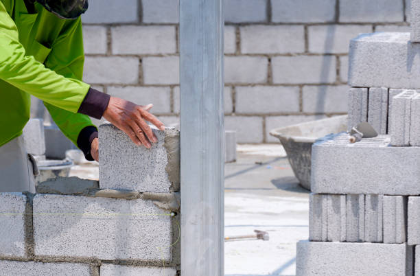 istock Cropped image of Asian builder worker making interior brick wall inside of house construction site 1407234845