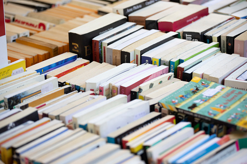 Trays of used books for sale outside a bookstore