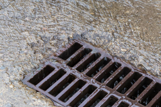 istock Rainwater running down to storm drain with cast iron grid 1407235606