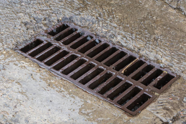 istock Rainwater running down to storm drain with cast iron grid 1407235611