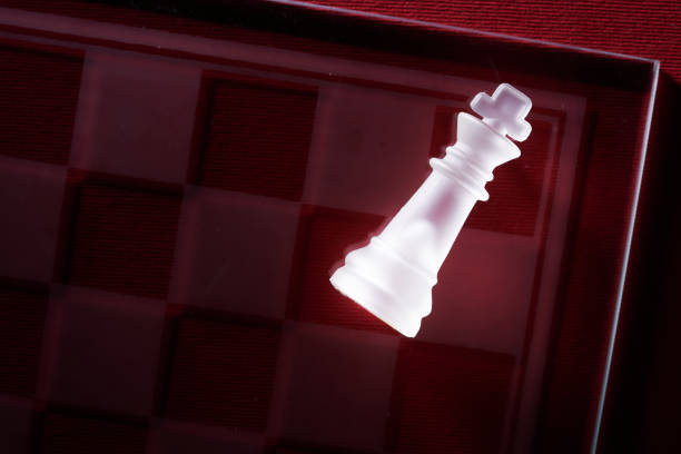 istock glass chess board with king chess piece on red background 1407235851