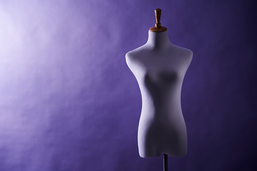 mannequin , dressmaker's model against purple background