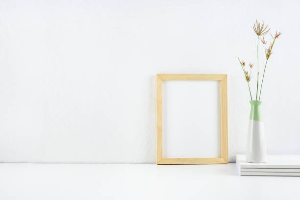 istock Professional business working space, workplace, office supply on a table desk e.g books, vase with weed, photo frame on white wall, contemporary theme. 1407239064