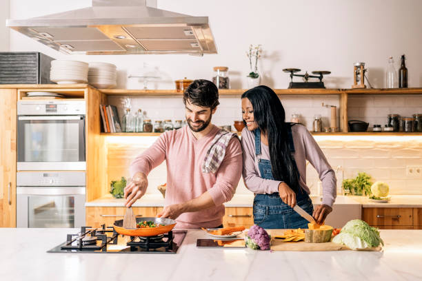 istock Cute Couple Cooking at Home 1407239975