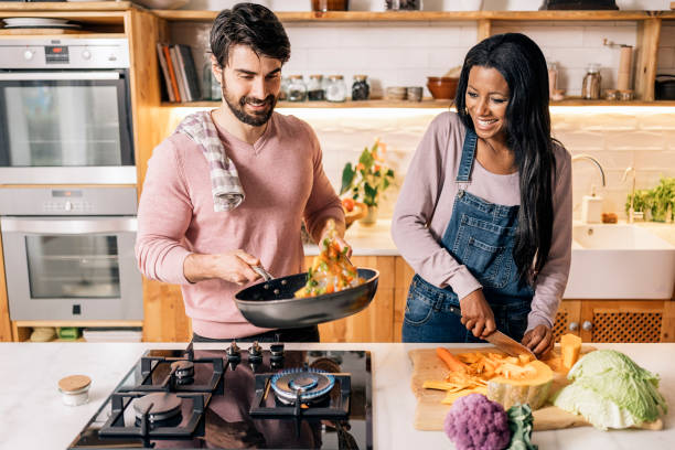 istock Cute Couple Cooking at Home 1407239981