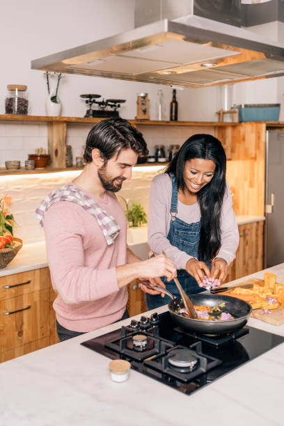 istock Cute Couple Cooking at Home 1407239983