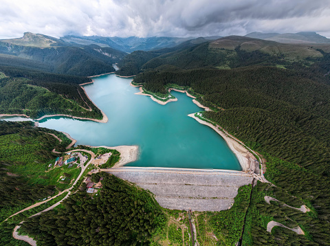 Aerial drone wide view of Bicaz lake and dam in Romania. Carpathian mountains covered with lush forest