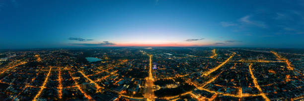 Aerial drone panoramic view of Chisinau at sunset, Moldova Aerial drone panoramic view of Chisinau downtown at sunset. Roads with multiple buildings, moving cars and illumination. Moldova chisinau photos stock pictures, royalty-free photos & images