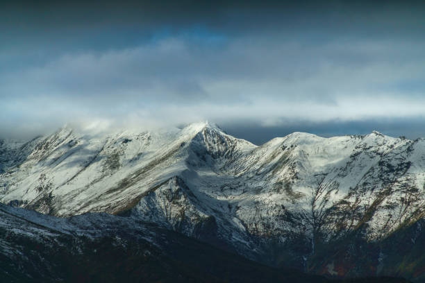 istock Mountain valley with fog and clouds 1407241795