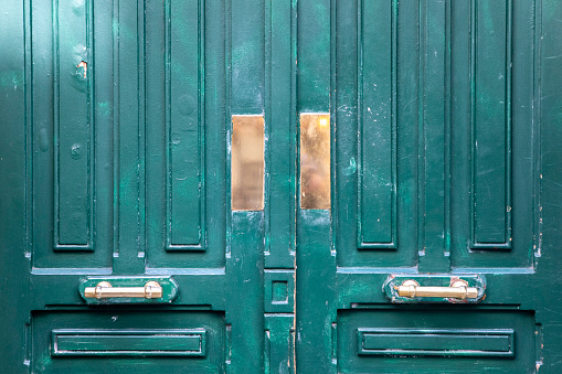 Background of old orange wooden doors with rough texture closed without key lock.
