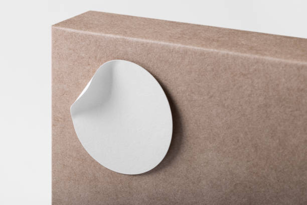 istock Rounded sticker mockup template on box package with copy space for your logo or graphic design 1407243297