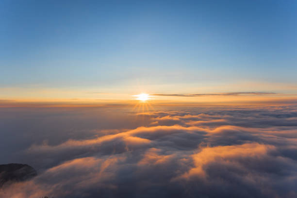 Sea of clouds and sunrise stock photo