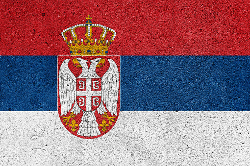 National flag of Serbia on a plastered wall