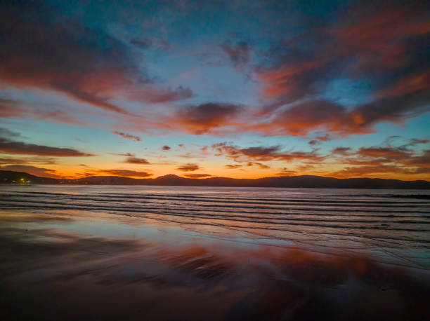 istock Winter sunrise at the seaside with high cloud and reflections 1407247668