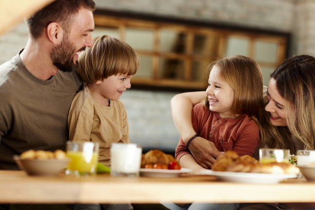 istock Happy family talking during a meal in dining room. 1407247843