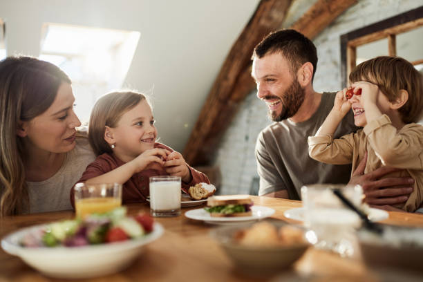 istock Happy family talking during breakfast at dining table. 1407248938