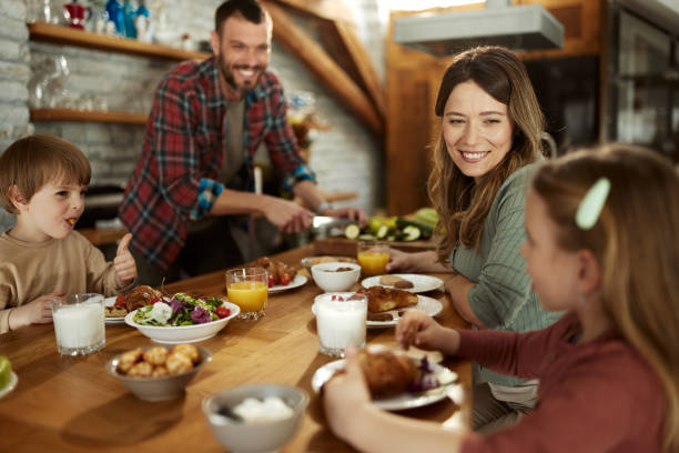 istock Young happy family talking during breakfast at dining room. 1407249205