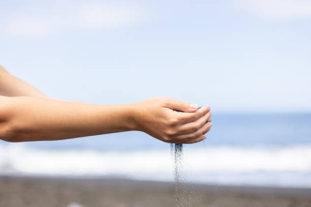 istock Female hands with sand. Summer holidays and vacation concept. 1407249462