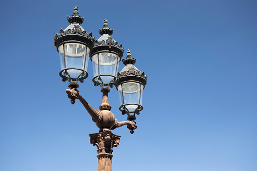 Lamppost with yellow light at dusk