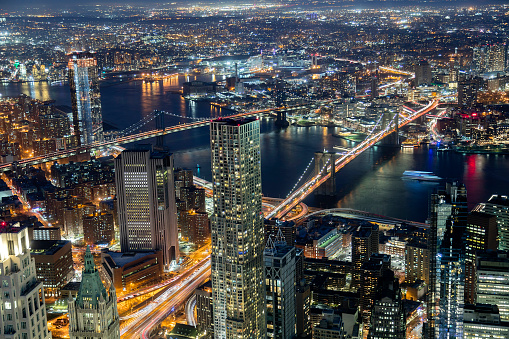 New York City illuminated at night, Manhattan and Brooklyn with East River, Manhattan Bridge and Brooklyn Bridge, aerial view.