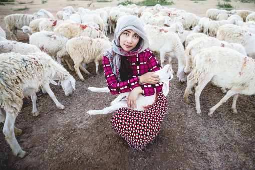 Female shepherd with little sheep