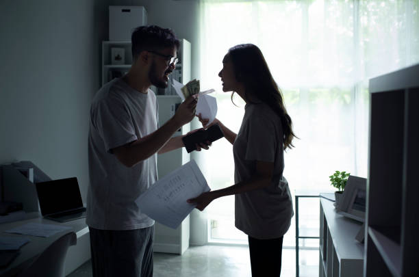Asian couple arguing about money at home. Asian couple arguing about money at home, husband and wife shouting in a hard quarrel by their many debts at home, financial family problems concept. fighting stock pictures, royalty-free photos & images