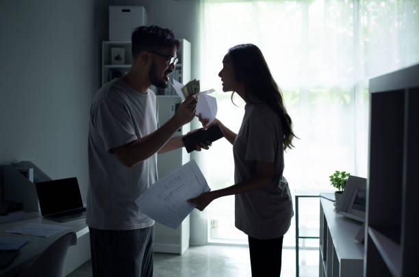 Asian couple arguing about money at home. Asian couple arguing about money at home, husband and wife shouting in a hard quarrel by their many debts at home, financial family problems concept. pictures of divorce papers stock pictures, royalty-free photos & images