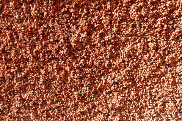Expanded clay concrete texture. Red pink relief plaster, consisting of expanded clay stones. Abstract background.
