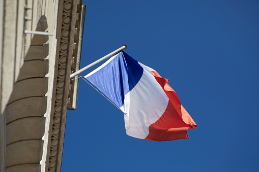 The French tricolour outside a civic building on Rue de Lutèce in Paris