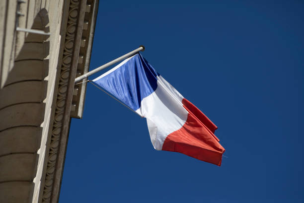 istock French national flag waving outside a city building viewed from a low angle 1407257955