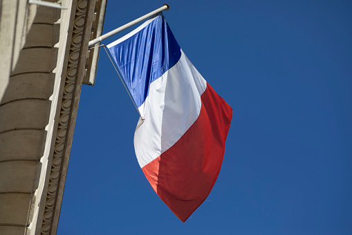 The French tricolour outside a civic building on Rue de Lutèce in Paris