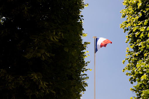 The French tricolour on a flagpole in Paris